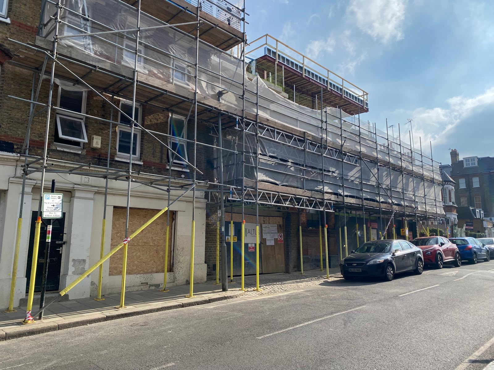 Scaffolding and sheeting along the front elevation.