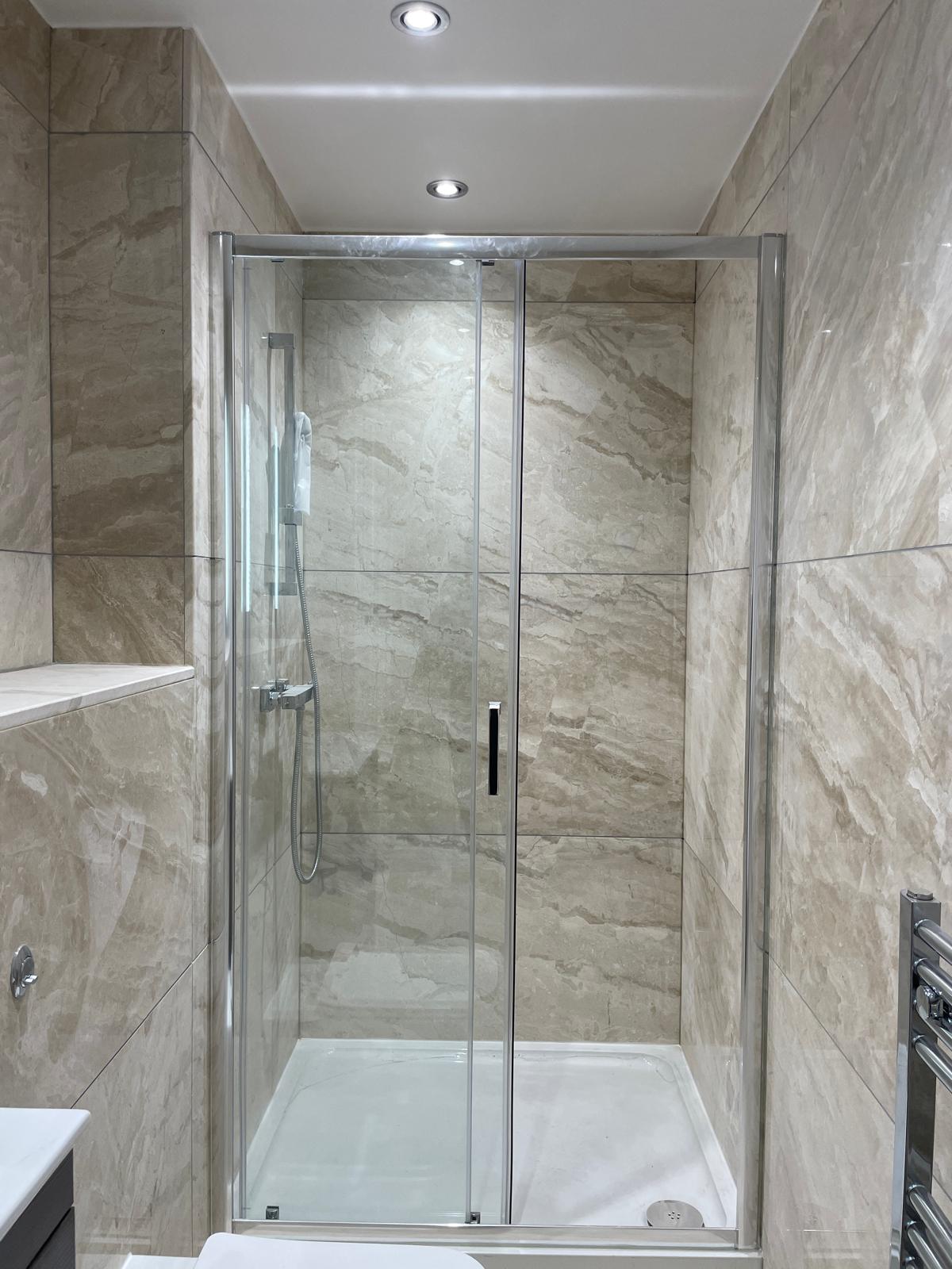 Finished shower room with large format tiling.