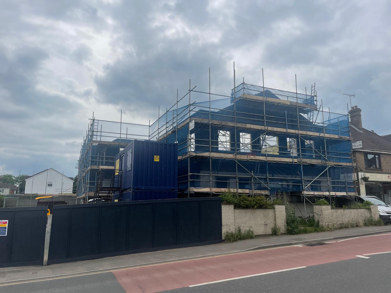 The site fully scaffolded, seen from the street.