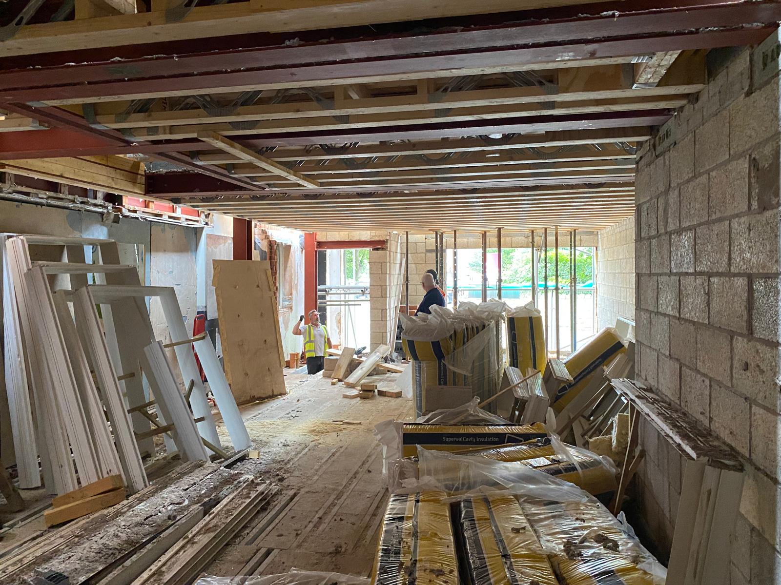 Internal strip out, with structural steel and joist hangers exposed.