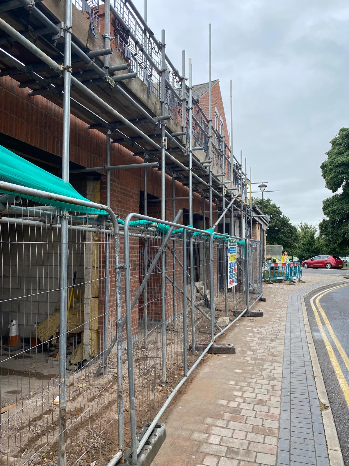 Construction progress on site with brickwork and scaffolding