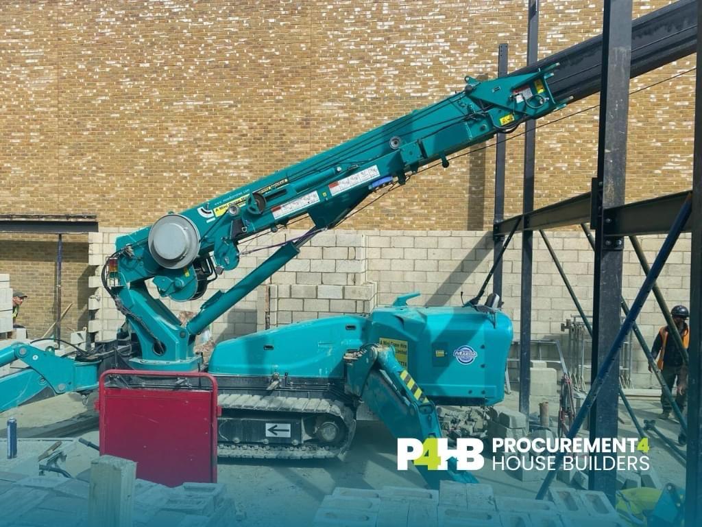 Mini crane lifting steel members into position.