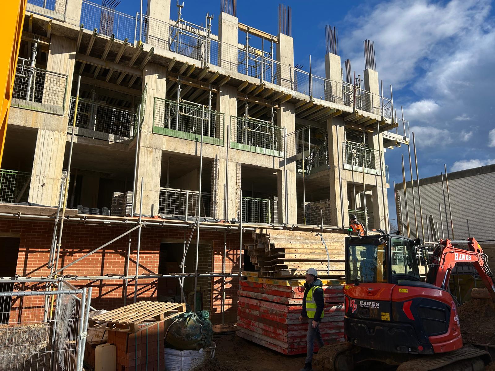 The concrete frame at Eastdown Park with brickwork starting on the lower floors.