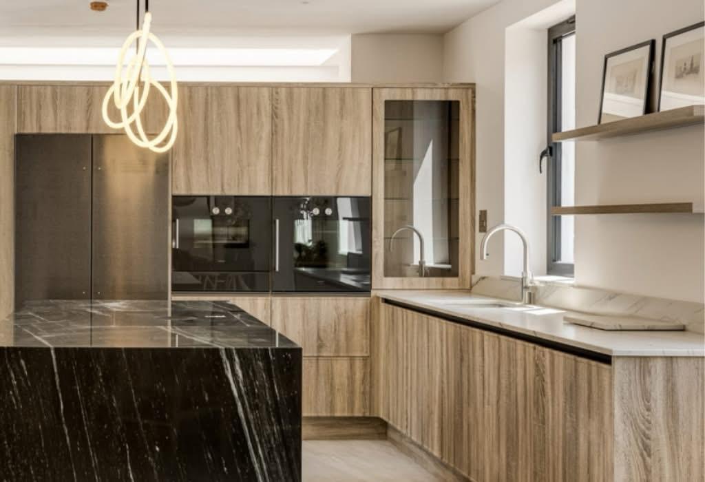 Finished kitchen, veneered cabinetry and stone worktops.