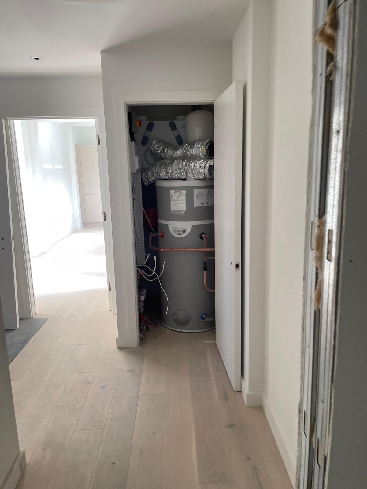 Hot water cylinder and services installed to the apartment.