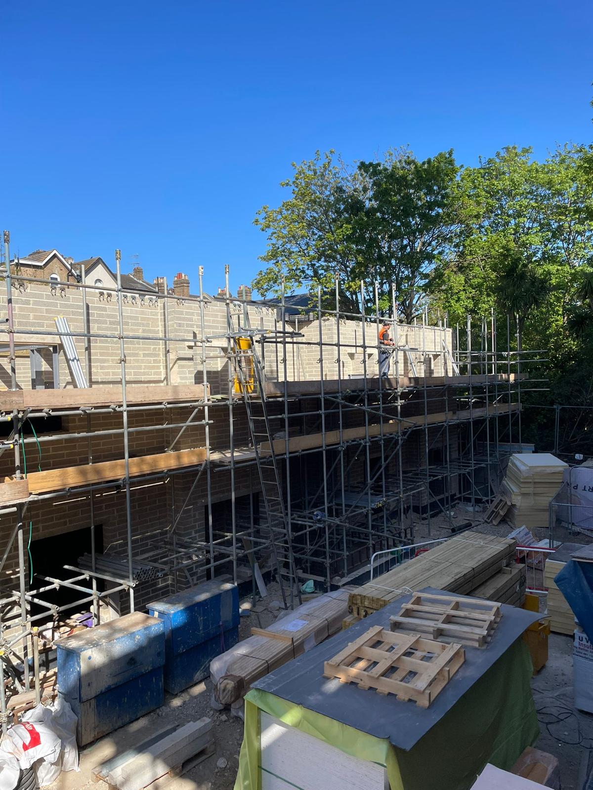 Insulation and timber staged at the rear of the site.
