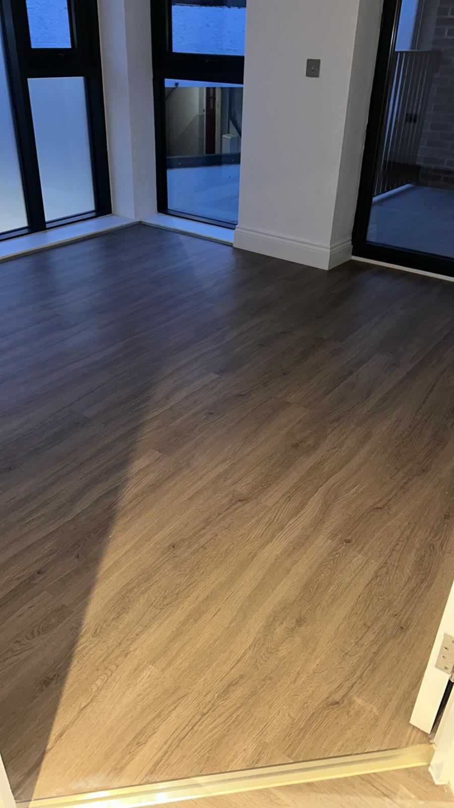 Living space with glazing and flooring complete.