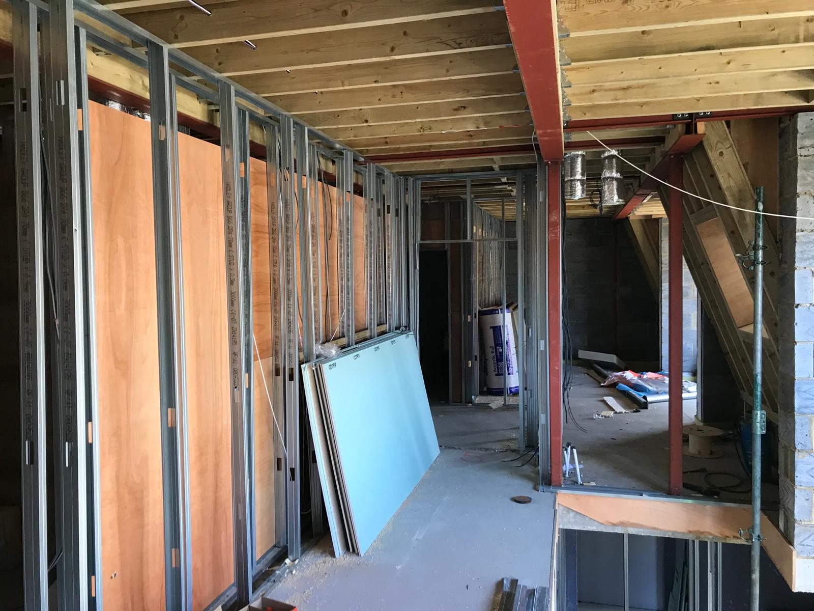 Corridor framing with stud walls, timber joists and steelwork.
