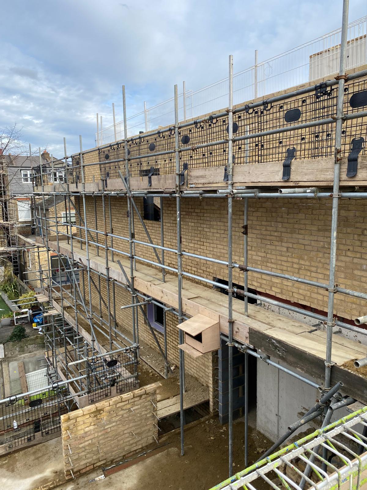 Brickwork and window openings formed to the upper floors.