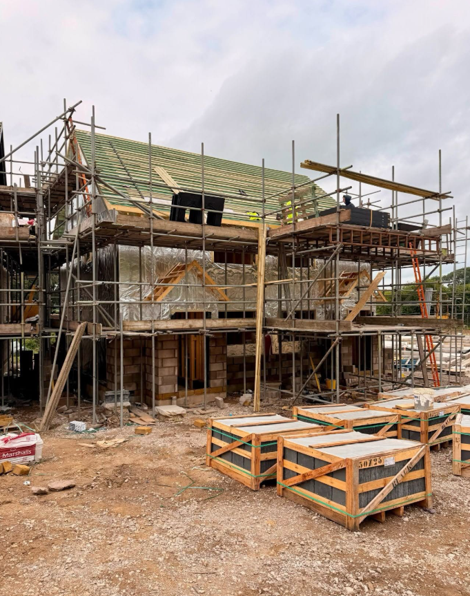 Timber roof structure being installed above a masonry ground floor