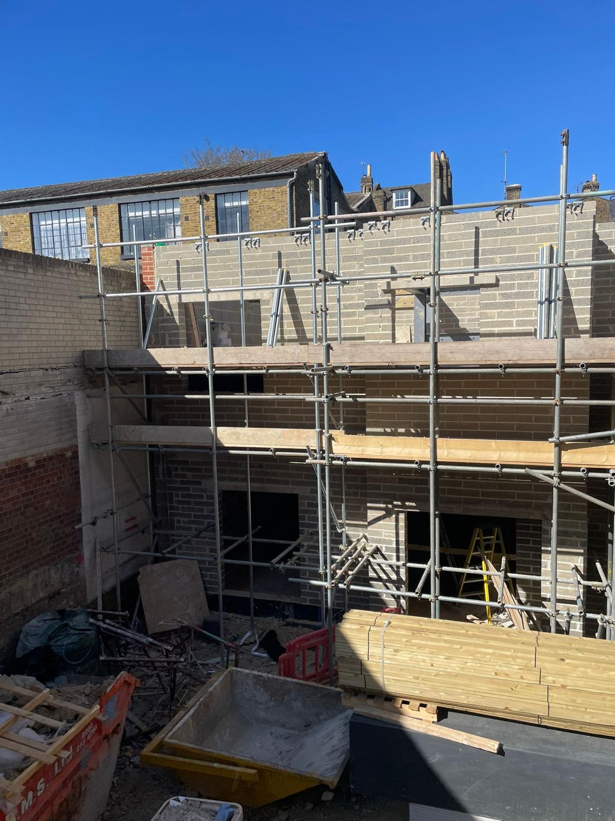 Blockwork rising across the rear elevation.