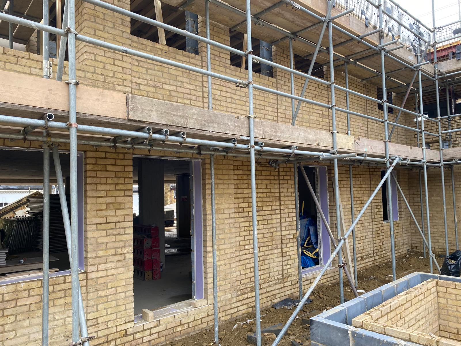 New brickwork progressing between the scaffold lifts.