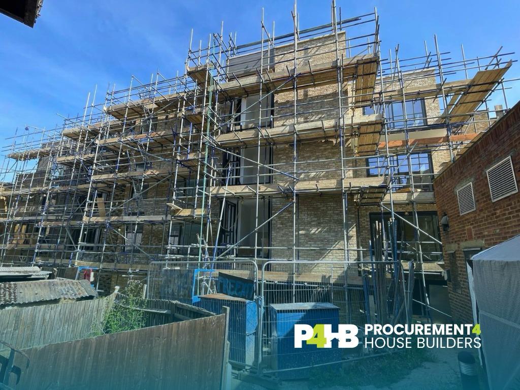 Facade progressing behind full height scaffolding.