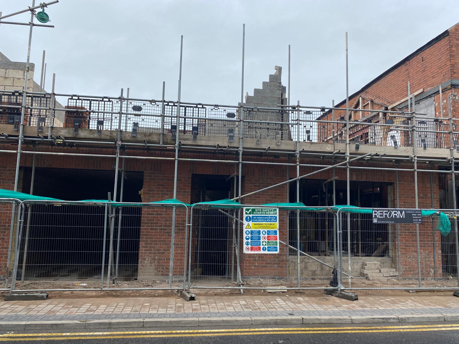 Street elevation scaffolded, with first floor blockwork progressing.