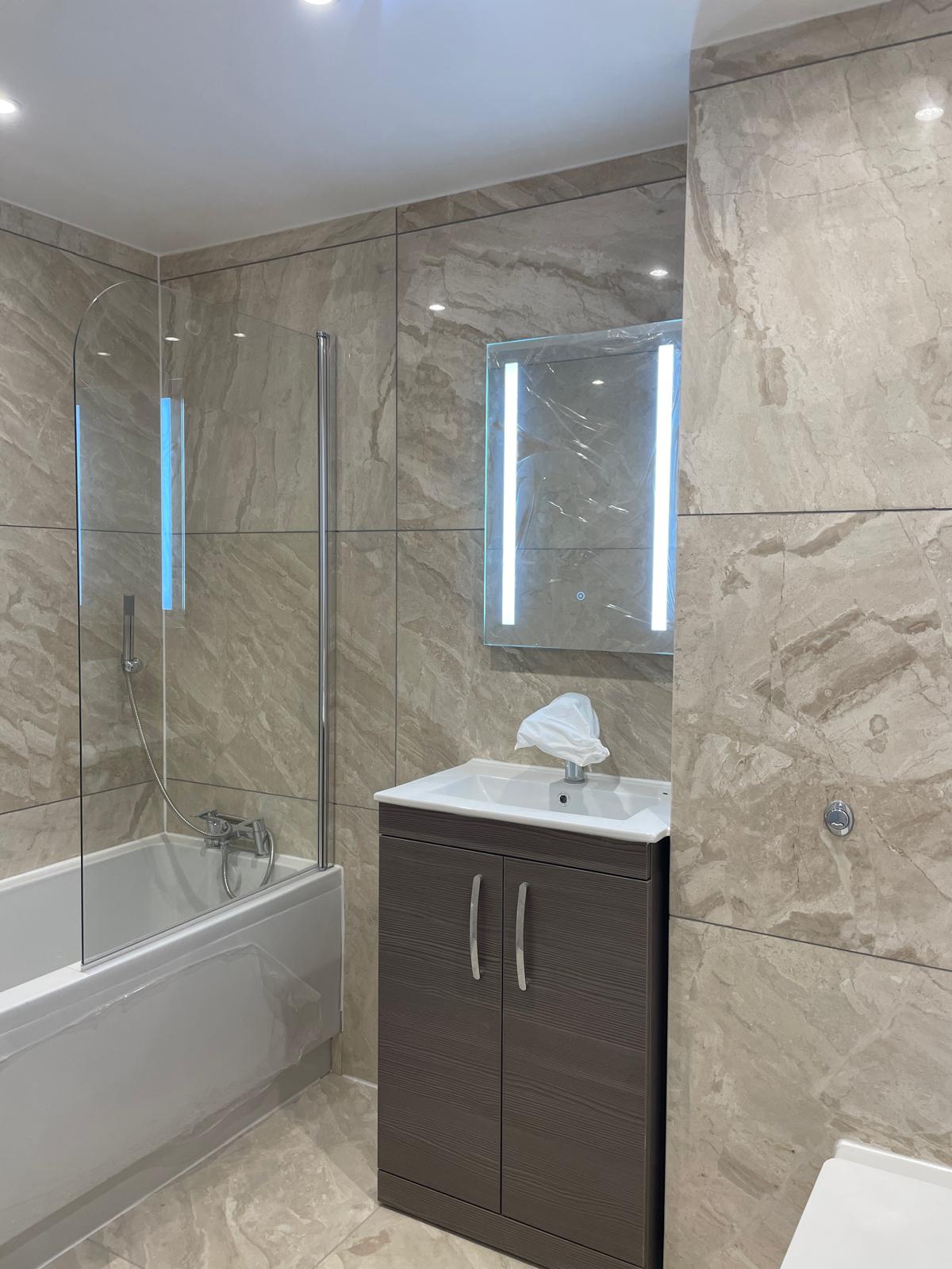 Main bathroom with bath and vanity unit.