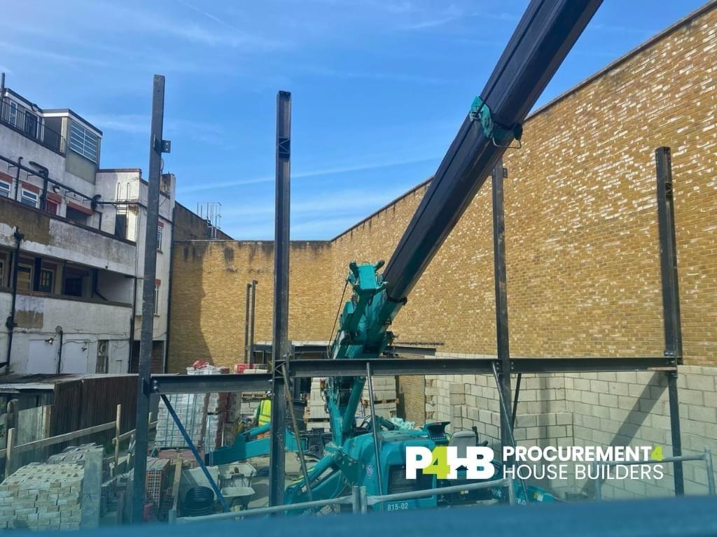 Steel frame erection between the existing buildings.
