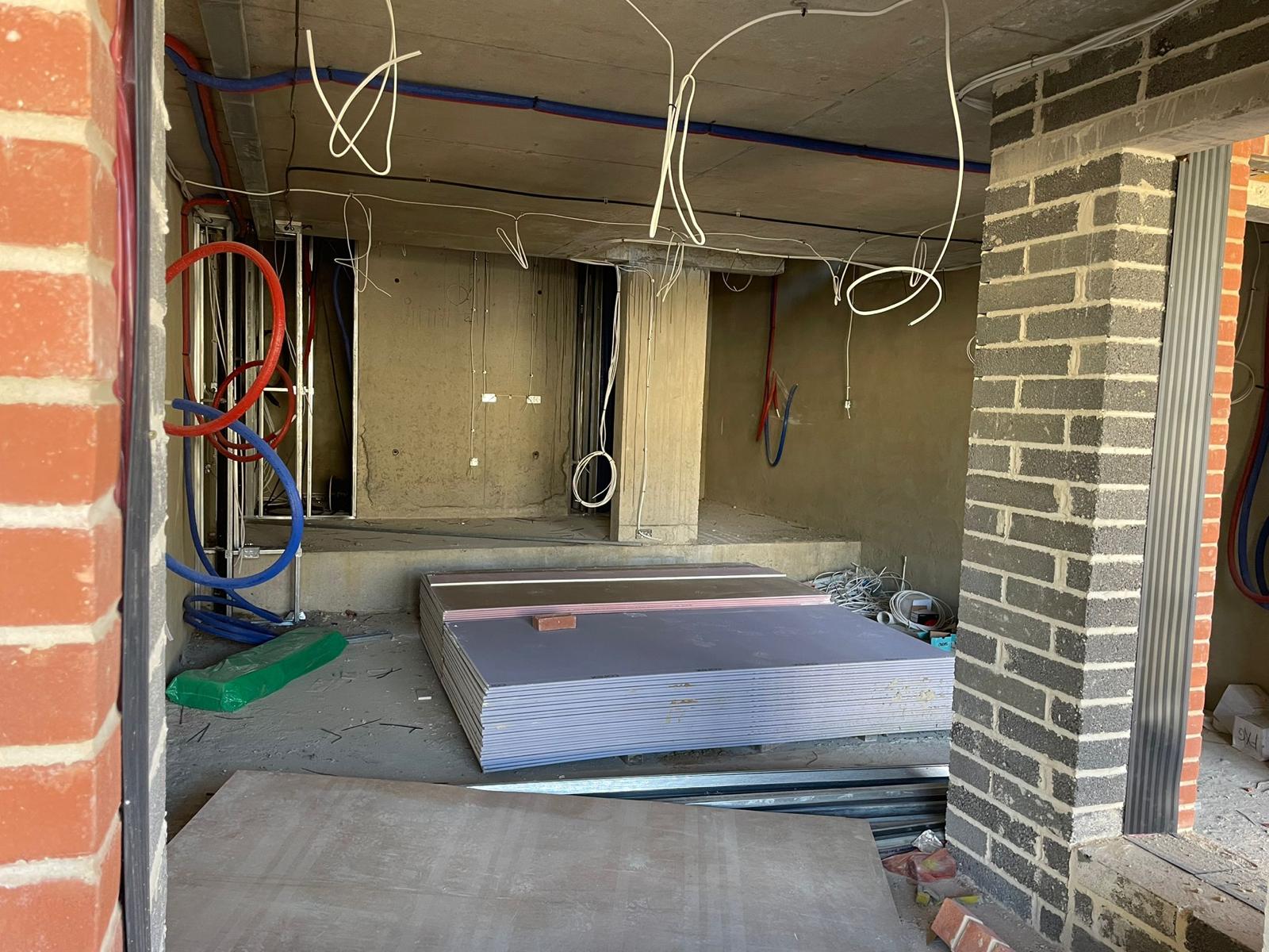 Plasterboard delivered into the building, stacked and ready.