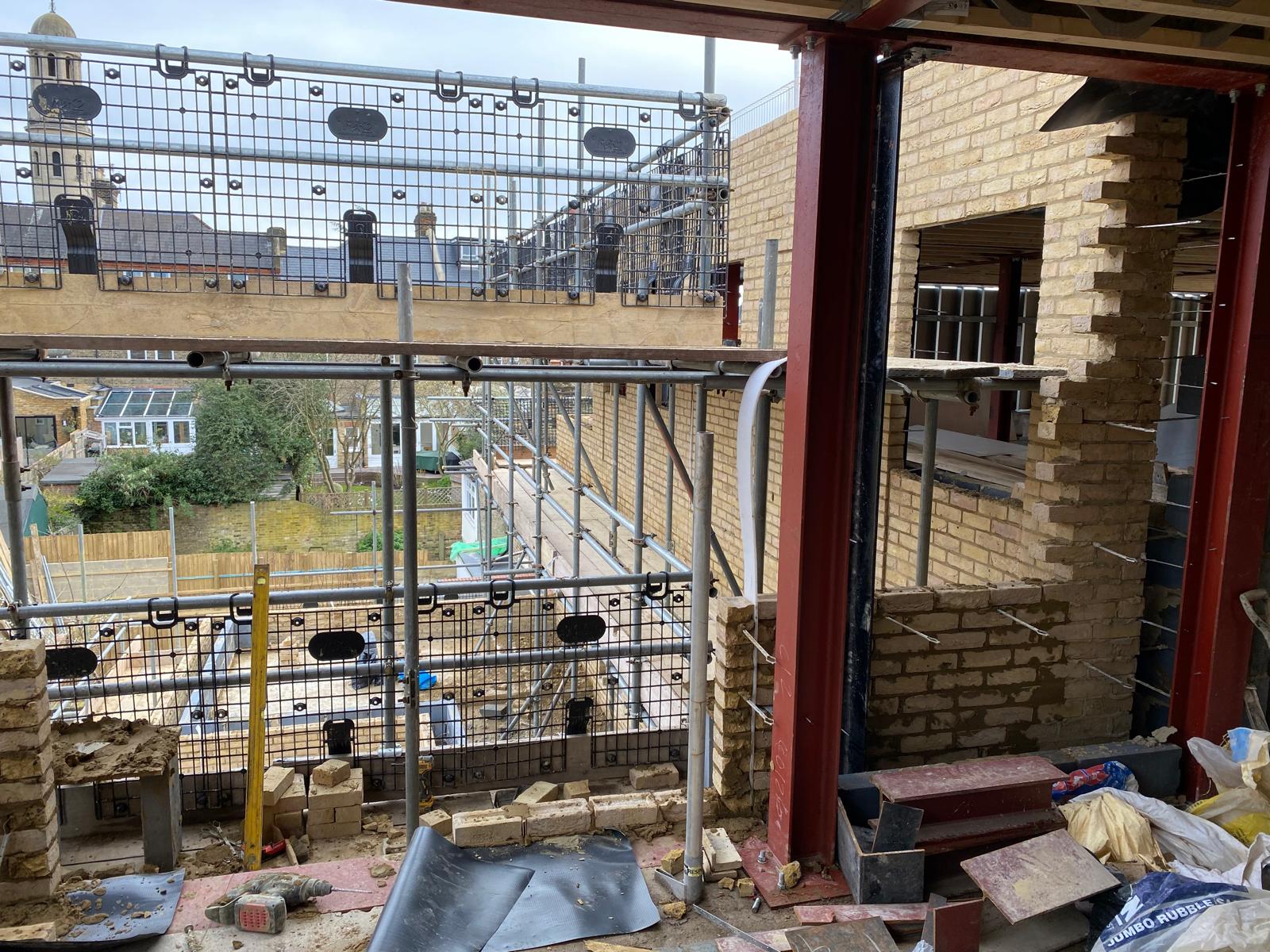 Structural steelwork integrated within the new brickwork.