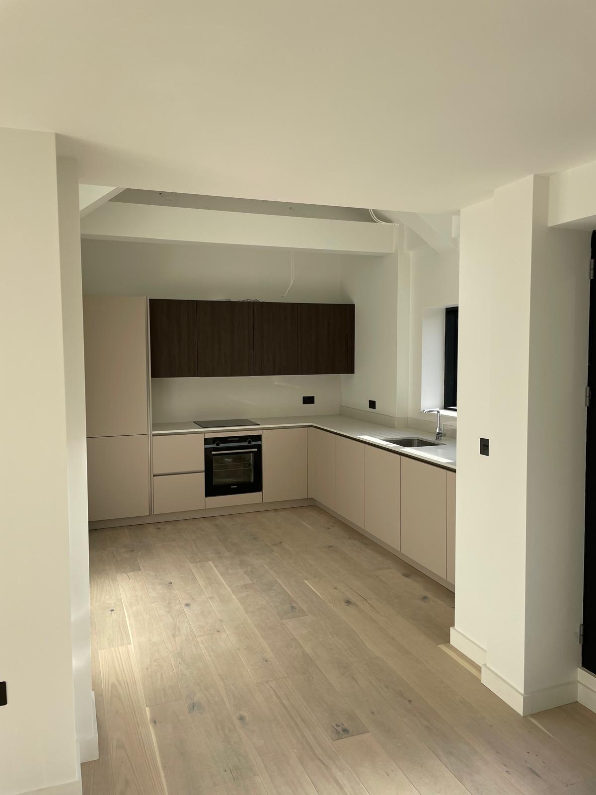 Kitchens and flooring progressing through the apartments.