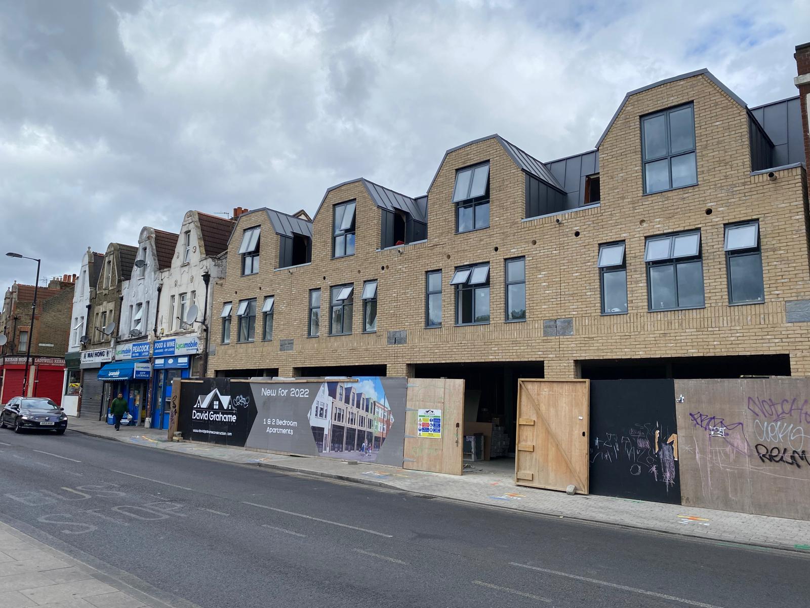The completed Ladywell elevation from the street, with the neighbouring shops.