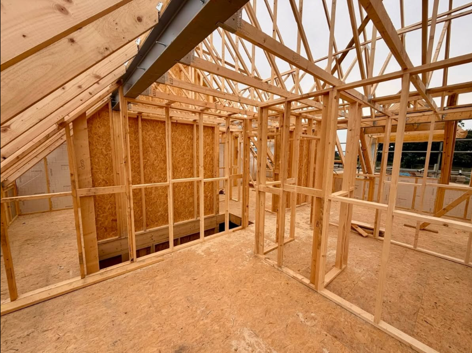 Timber frame upper floor and complex roof trusses during erection