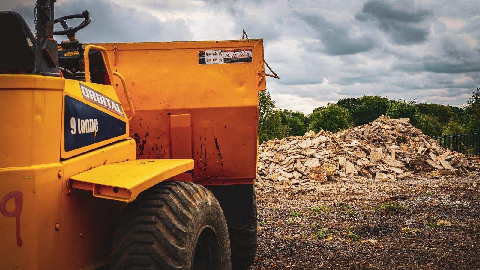 Demolition rubble being moved with a site dumper.